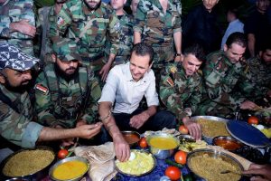 A handout picture made available on the Syrian Presidency Facebook page on June 26, 2016 shows Syrian President Bashar al-Assad (C) having Iftar dinner with Syrian soldiers ain al-Marj region in Damascus province during the Muslim holy month of Ramadan.  - RESTRICTED TO EDITORIAL USE - MANDATORY CREDIT "AFP PHOTO / HO / OFFICIAL FACEBOOK PAGE OF THE SYRIAN PRESIDENCY" - NO MARKETING NO ADVERTISING CAMPAIGNS - DISTRIBUTED AS A SERVICE TO CLIENTS  / AFP / Syrian Presidency Facebook page / HO / RESTRICTED TO EDITORIAL USE - MANDATORY CREDIT "AFP PHOTO / HO / OFFICIAL FACEBOOK PAGE OF THE SYRIAN PRESIDENCY" - NO MARKETING NO ADVERTISING CAMPAIGNS - DISTRIBUTED AS A SERVICE TO CLIENTS